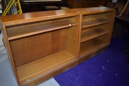 A pair of mid Century golden oak bookcases, having sliding glass doors