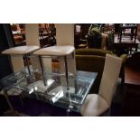 A modern glass extending dining table , having chrome frame and set of six complimenting chrome