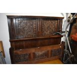 A Period oak carved panel bed head and foot