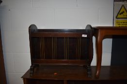 A reproduction Regency mahogany magazine rack having lion mask handles