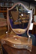 A 19th Century toilet mirror having shaped drawer base