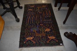 A Persian rug having vibrant animalistic style decoration, approx. 130 x 80cm