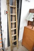 A set of vintage wooden extending ladders