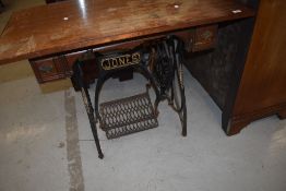 An Antique treadle Jones sewing machine base, with later wooden top