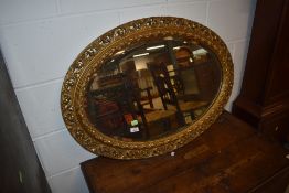 A gilt frame oval wall mirror