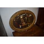 A gilt frame oval wall mirror