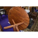 A vintage teak circular dining table on shaped legs, top in a parquet style, diameter approx. 120cm