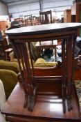 An early 20th Century mahogany nest, top table possibly having had top replaced, two undertables