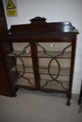 An early 20th Century mahogany bookcase/display cabinet having ball and claw feet