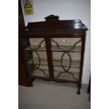 An early 20th Century mahogany bookcase/display cabinet having ball and claw feet