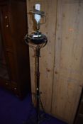 A wrought metal standard lamp, originally probably gas or oil and converted to electric, old