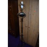 A wrought metal standard lamp, originally probably gas or oil and converted to electric, old