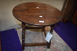 A traditional oak coffee table having circular top, diameter approx. 50cm