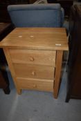 A modern golden oak effect three drawer chest