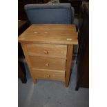 A modern golden oak effect three drawer chest