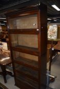 An early 20th Century stacking bookcase by Lebus, comprising drawer base, 5 glazed tiers and