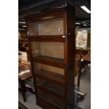 An early 20th Century stacking bookcase by Lebus, comprising drawer base, 5 glazed tiers and