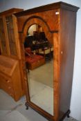 A late 19th/early 20th Century mirror door wardrobe, possibly from part of a larger set and