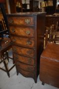 A reproduction walnut narrow chest of seven drawers, Reprodux or similar