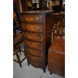 A reproduction walnut narrow chest of seven drawers, Reprodux or similar