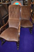 A ladies and gents pair of Victorian mahogany scroll frame rocking chairs having later dralon button