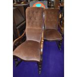 A ladies and gents pair of Victorian mahogany scroll frame rocking chairs having later dralon button