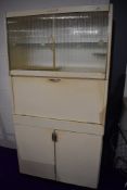 A vintage kitchenette, labelled Eastham, sliding glazed doors to upper section, central servery with