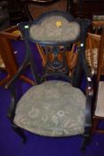 A late Victorian dark stained frame armchair having upholstered seat and back