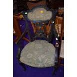 A late Victorian dark stained frame armchair having upholstered seat and back