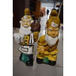 A pair of large garden gnomes having comedic theme, height approx. 76cm