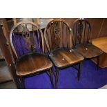 Three vintage dark stained Ercol Fleur de lys style dining chairs