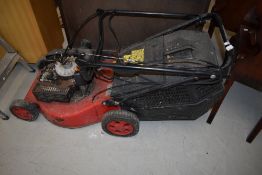 A petrol lawnmower, as found