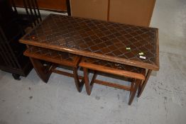 A vintage teak and tile top coffee table nest