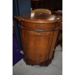 A reproduction mahogany effect corner cupboard base