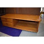 An Ercol mid colour Minerva style coffee table, width approx. 125cm