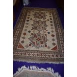 A Persian style rug, predominantly cream and russet, approx. 130 x 95cm