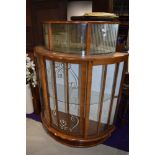 A mid 20th Century walnut demi lune display cabinet