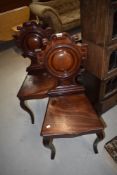 A pair of 19th Century mahogany shield back hall chairs