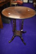 A late 19th/early 20th Century circular occasional table, on four turned columns and splay legs,