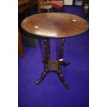 A late 19th/early 20th Century circular occasional table, on four turned columns and splay legs,