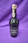 A bottle of Dows 1963 Vintage Port with original paper label and seal