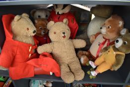 A shelf of 1980's and later teddy bears including Teddy Ruxpin, Teleconcepta, Paddington, Badger etc
