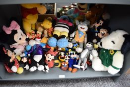A shelf of Mickey Mouse, Winnie the Pooh, Snoopy and similar soft toys and collectables