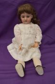 An early 20th century German Armand Marseille Bisque Socket Headed Doll having sleep blue eyes, open