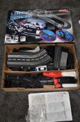 A Artin 1:43 scale Stunt Raceway Slot Racing Set with two cars, controllers, track, control unit and