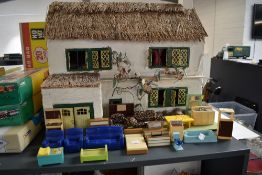 A vintage wooden hand made two storey Dolls House in the Farm House style having thatched effect