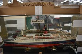 A plastic model, Cunard Ship, Queen Elizabeth 2, in glass display case (af)