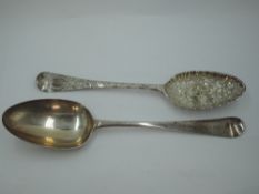 A Georgian silver berry spoon having frilled rim to bowl and later chased stem, London 1749,