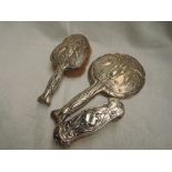 An Edwardian silver backed hand mirror and brush having Art Nouveau style stork and water lily