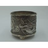 An early 20th Century Chinese silver salt having repousse dancing dragon decoration with plain